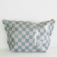 Checkered bag with a clear plastic cover on a white background